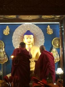 H.E. Jamgon Kongtrul Rinpoche (l) and Karma Wangchuk (r) painting the Buddha in the main Stupa in Bodhgaya.